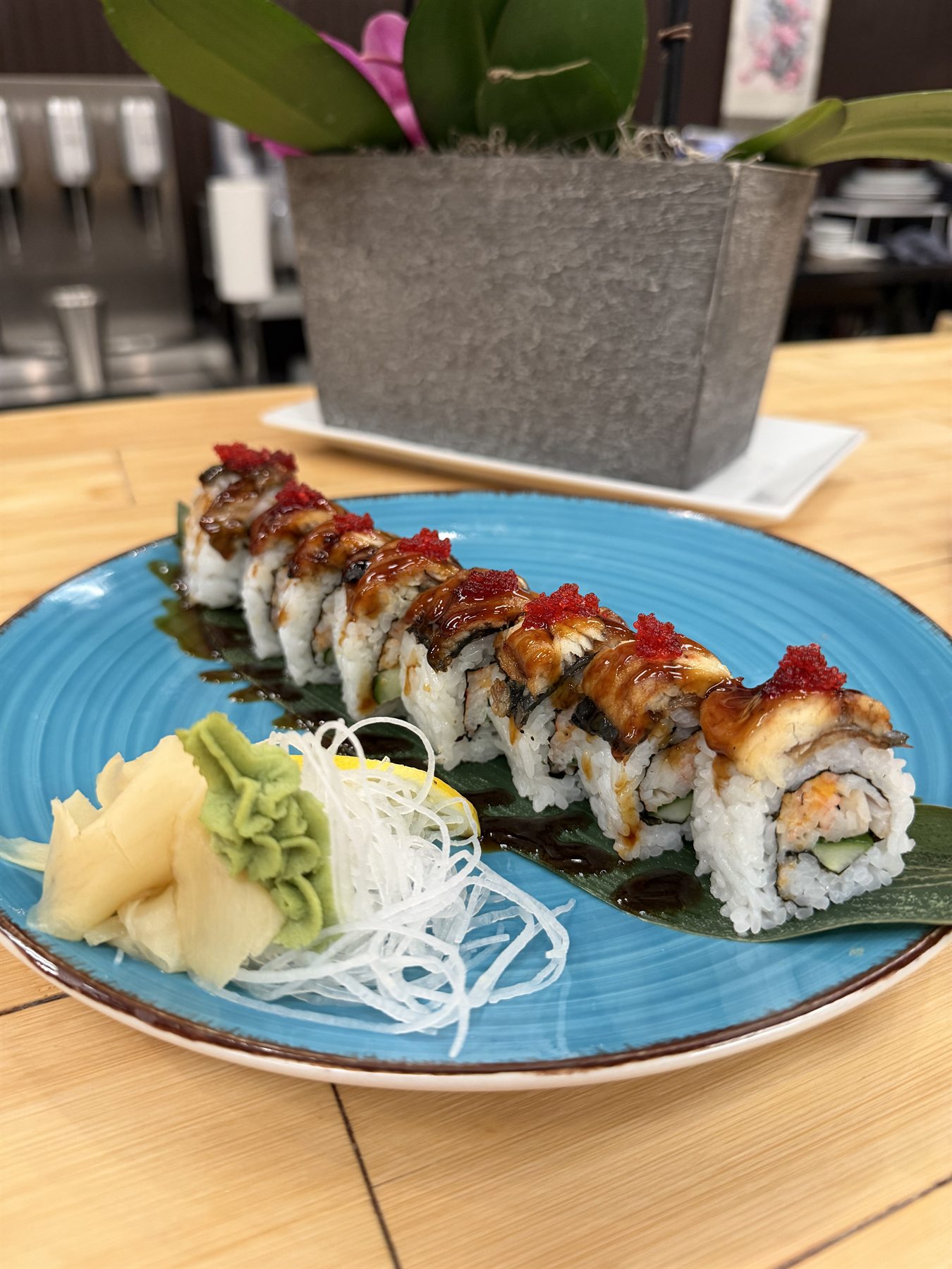 Eel and cucumber sushi roll topped with tobiko and drizzled with eel sauce