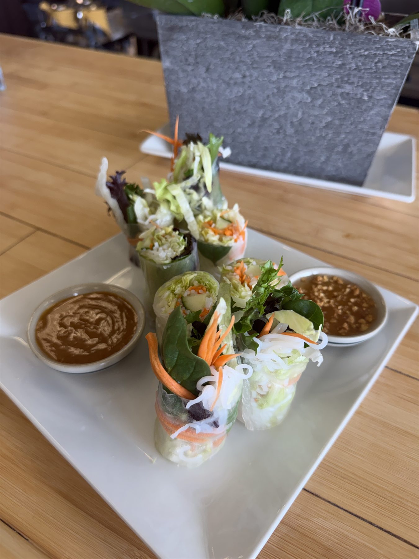 Fresh spring rolls sliced open, showing rice noodles, lettuce and carrots
